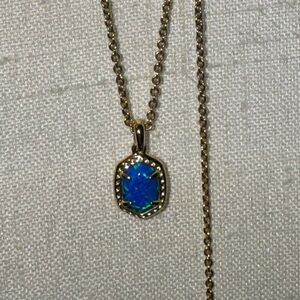 Kendra Scott Gold Adjustable Necklace paired with an Iridescent Blue Pendant